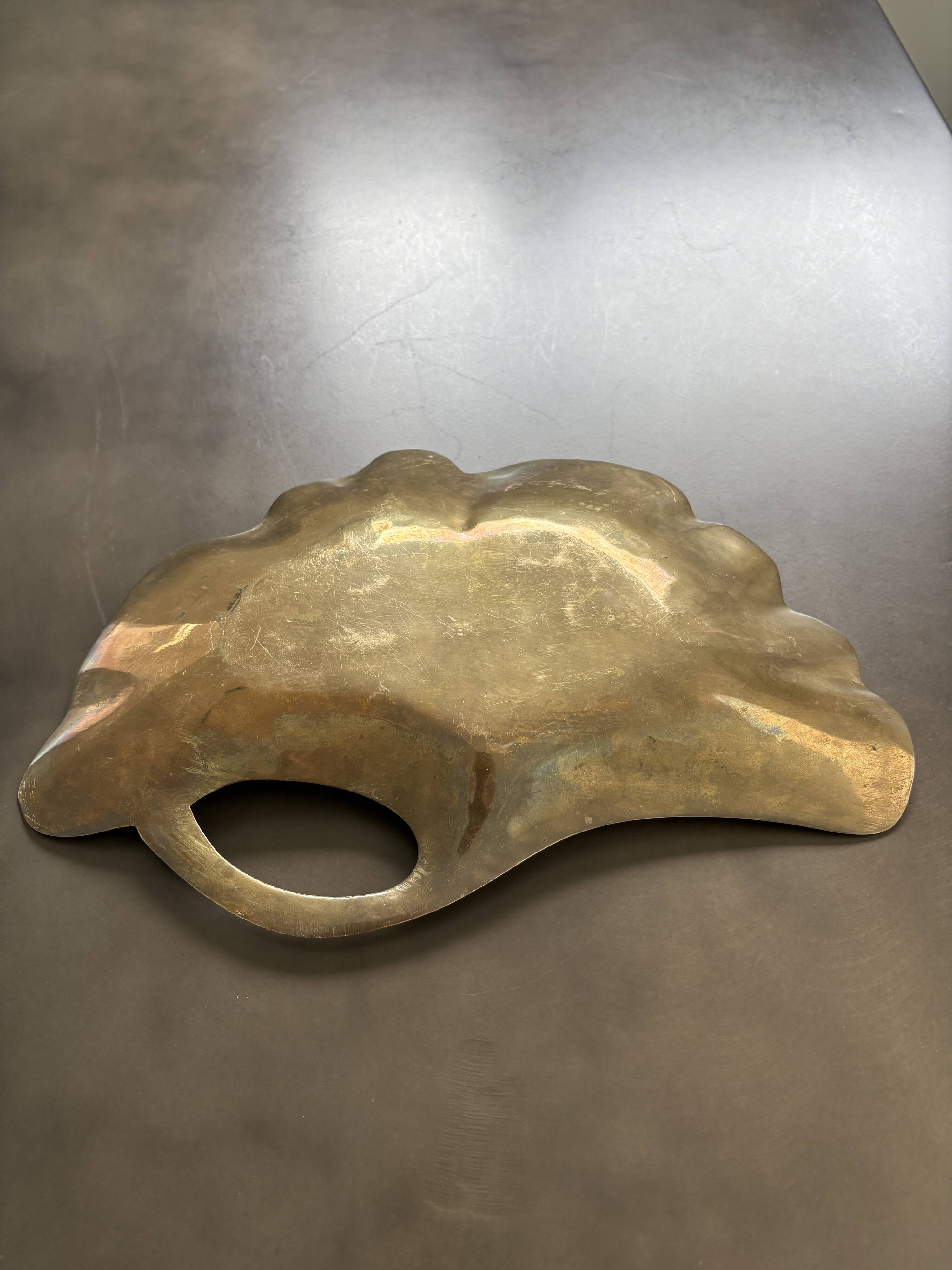 Old brass pocket emptier