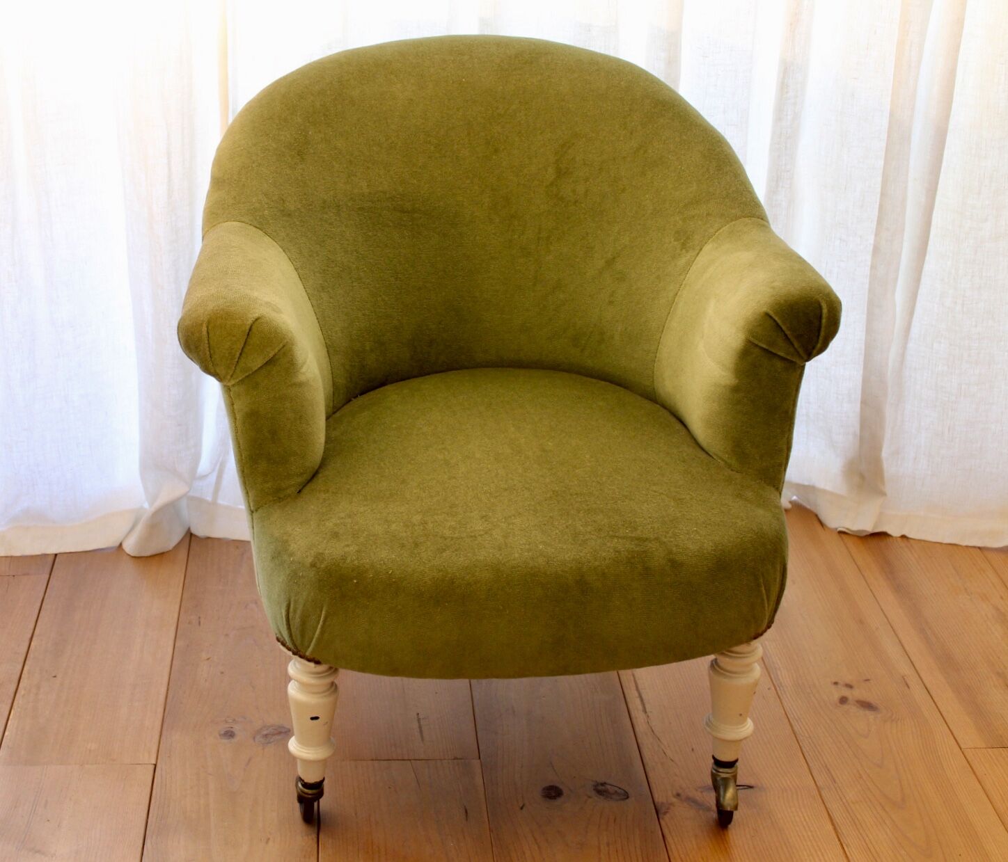 Toad in almond green velvet armchair on castors