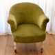 Toad in almond green velvet armchair on castors