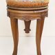 Swivel piano stool with screw, Louis XV style, in walnut.