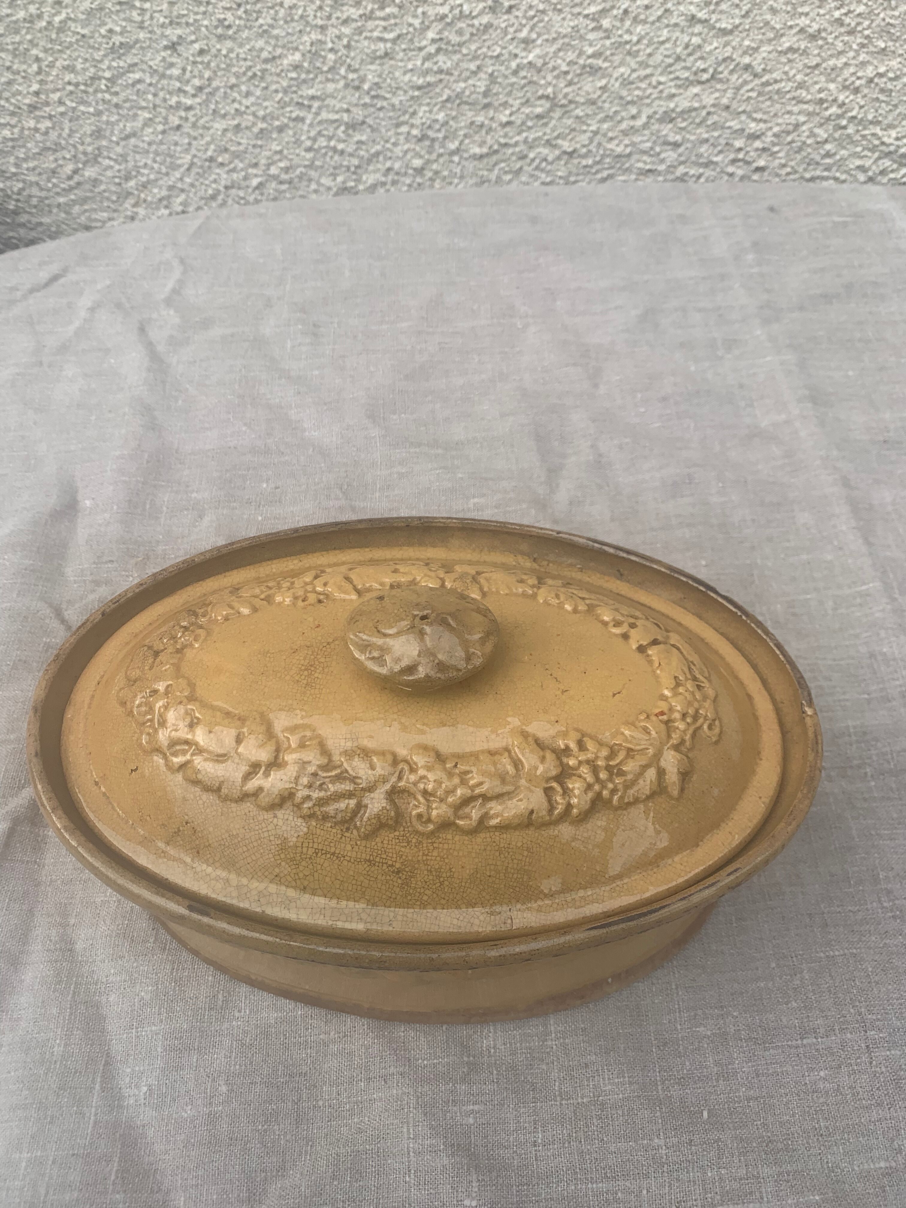 Old terrine in glazed stoneware and floral decoration mustard yellow slip