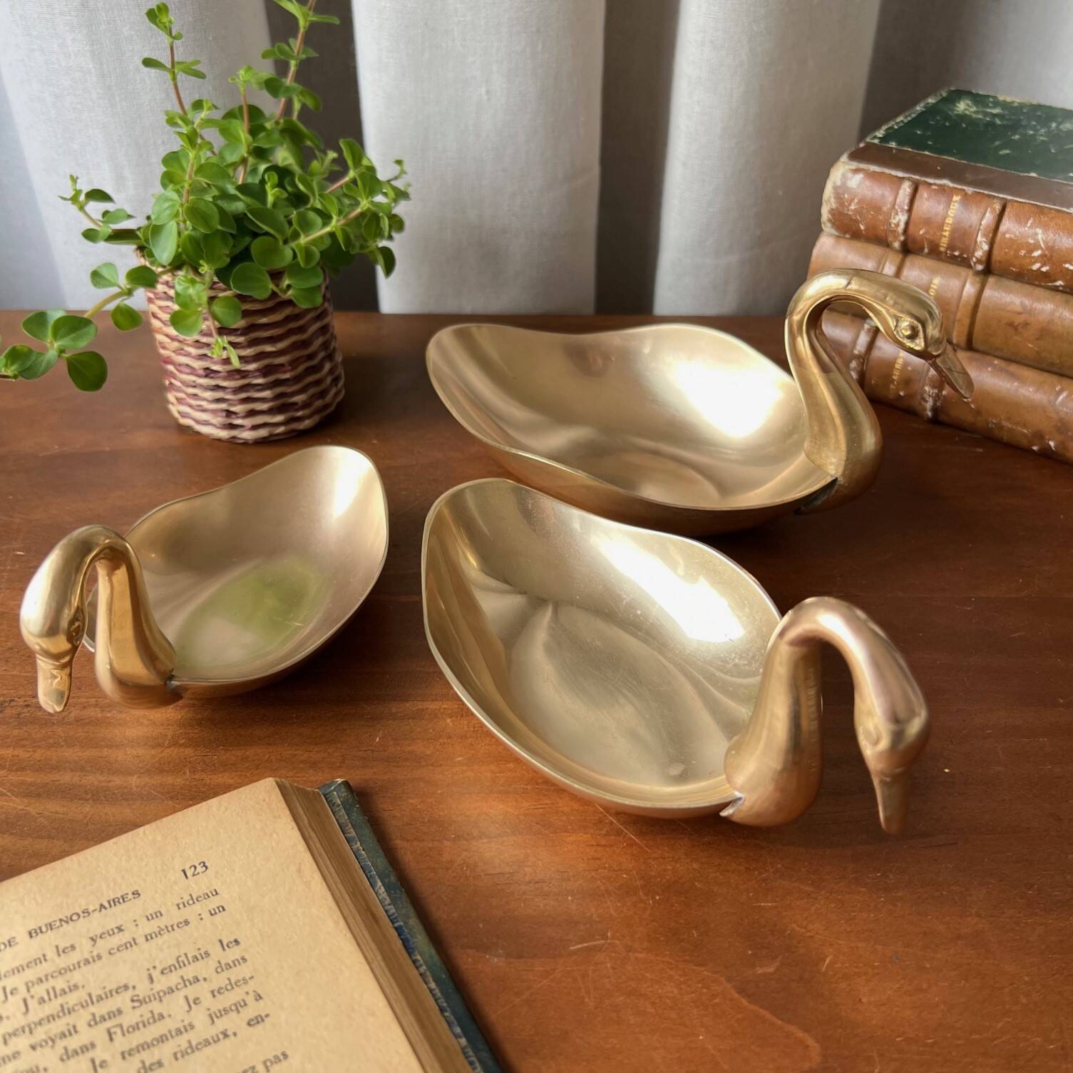 Trio of “swan” cups in gilded brass