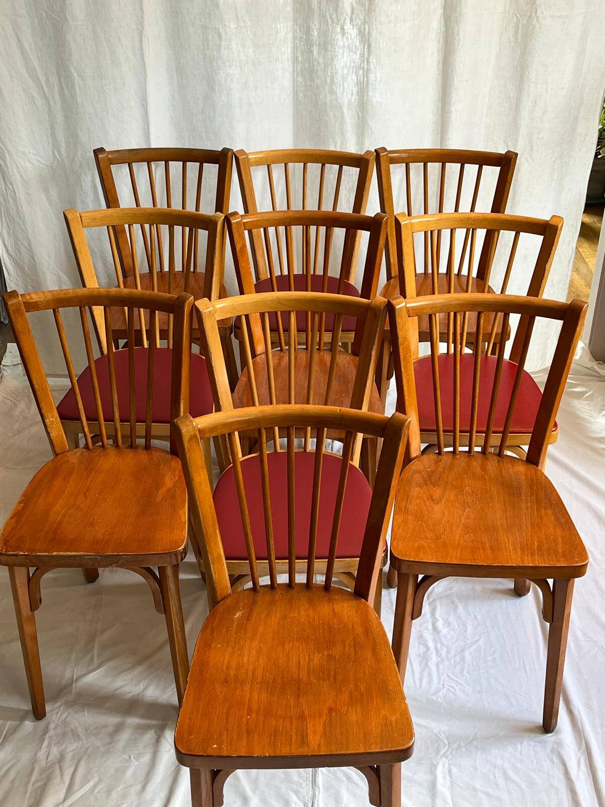 Set of Baumann bistro chairs with a mix of wooden seat and faux leather.