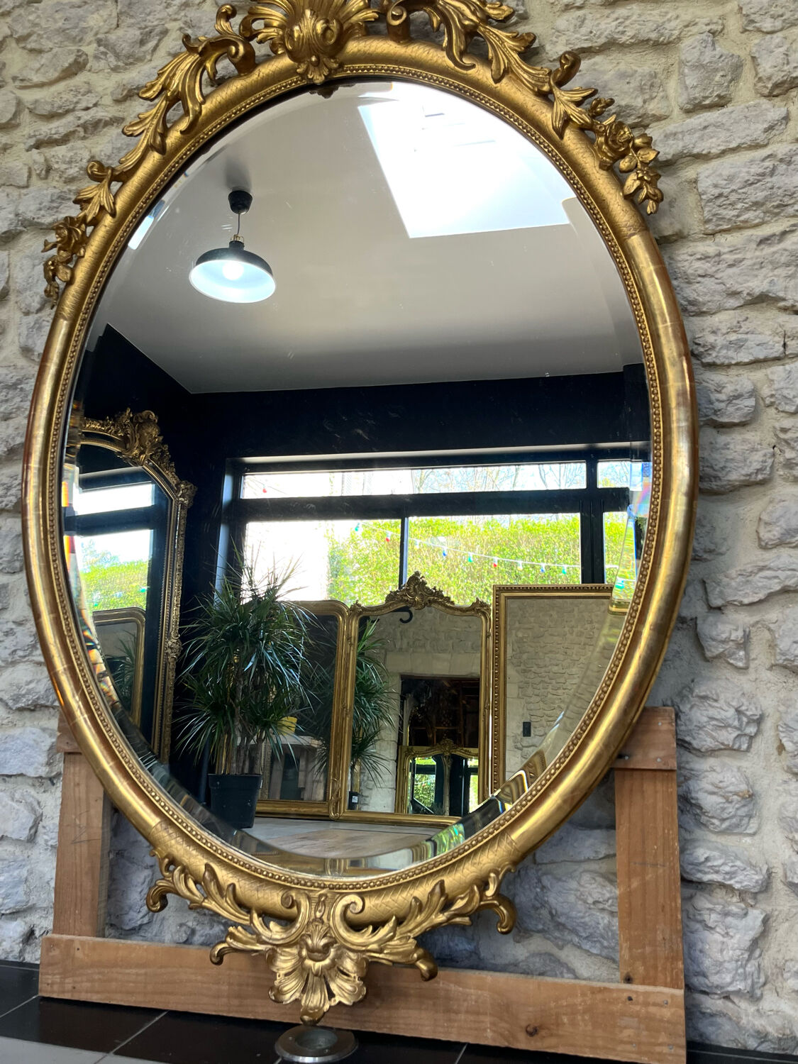 Oval mirror with pediment, beaded gilded with gold leaf