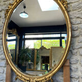 Oval mirror with pediment, beaded gilded with gold leaf