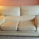 Two-seater convertible sofa bed in off-white leather by Ligne Roset.