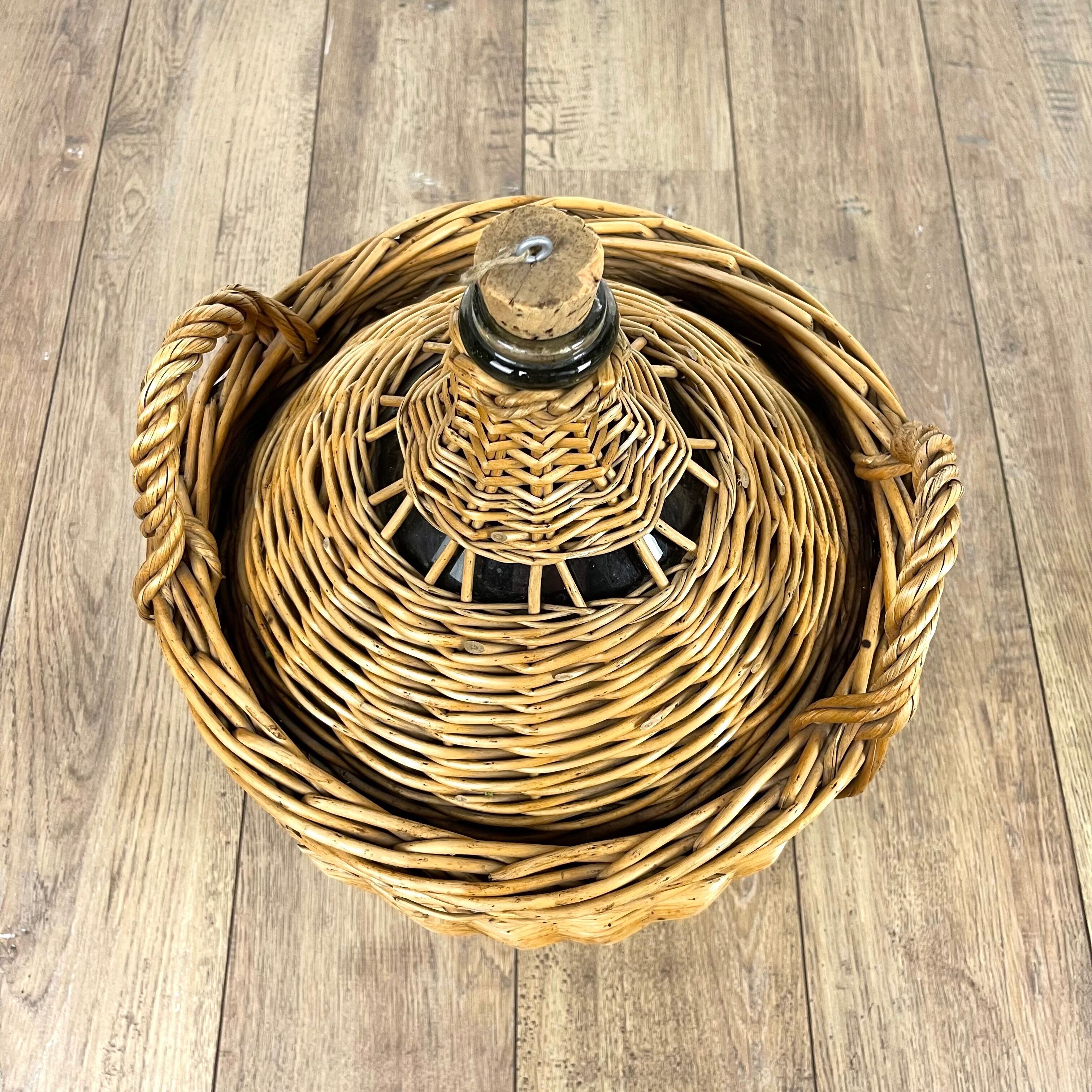 Old demijohn in her wicker basket