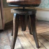 Old leather rotating piano stool