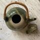 Handmade ceramic teapot with green fish and bamboo