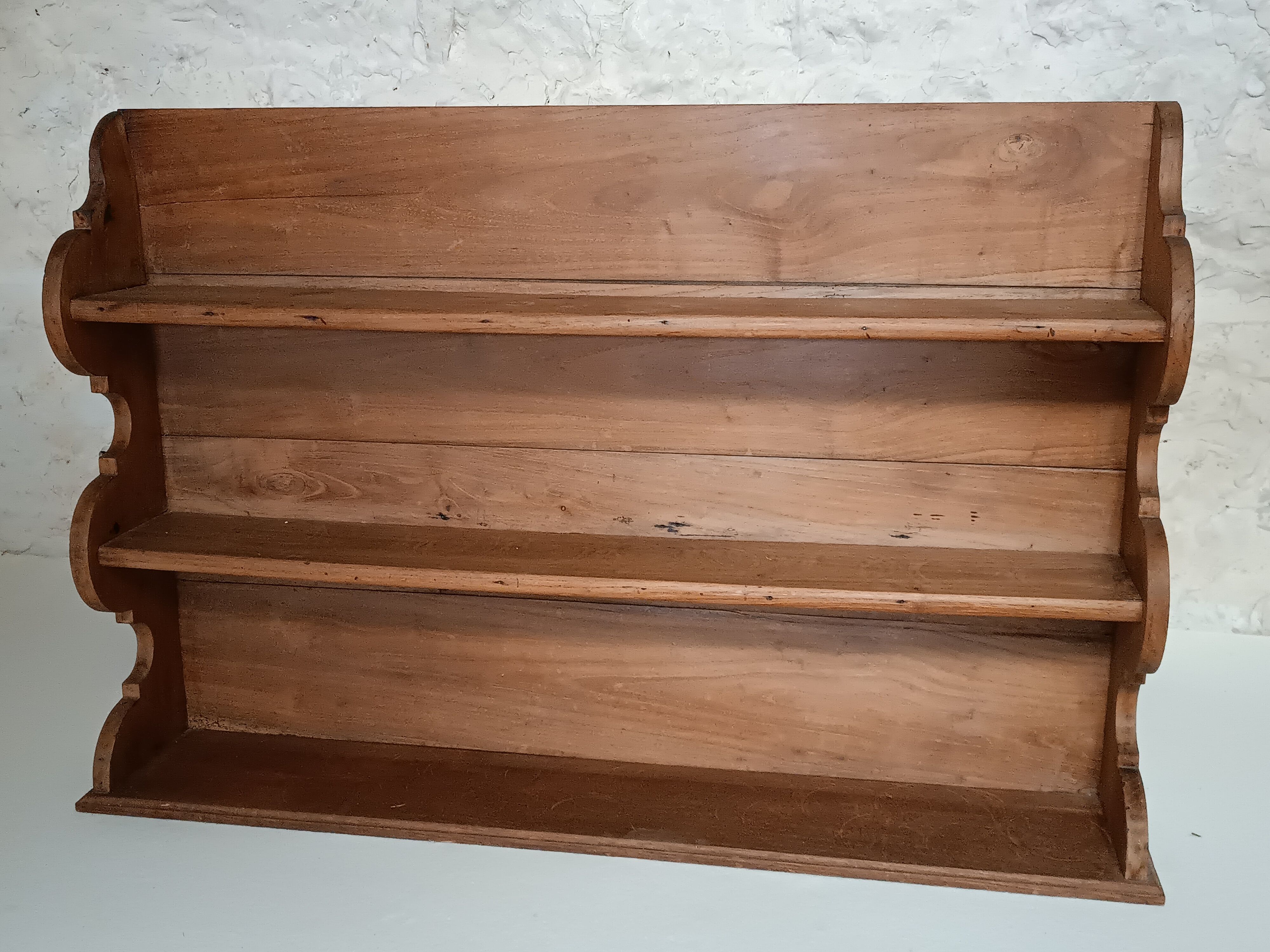 Old wall shelf in raw wood