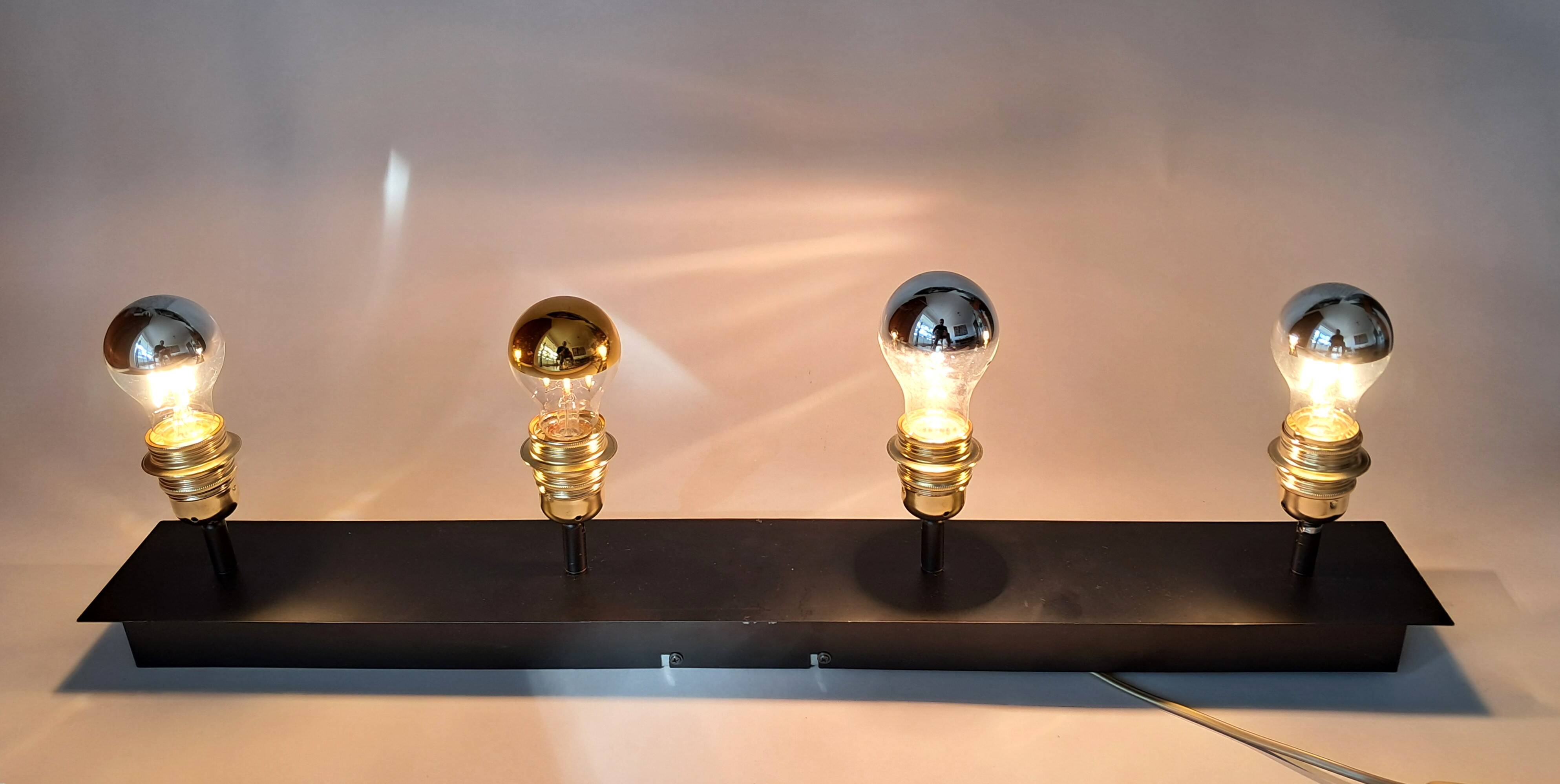 Wall lamp with 4 adjustable lights in black metal and gold-plated brass sockets.