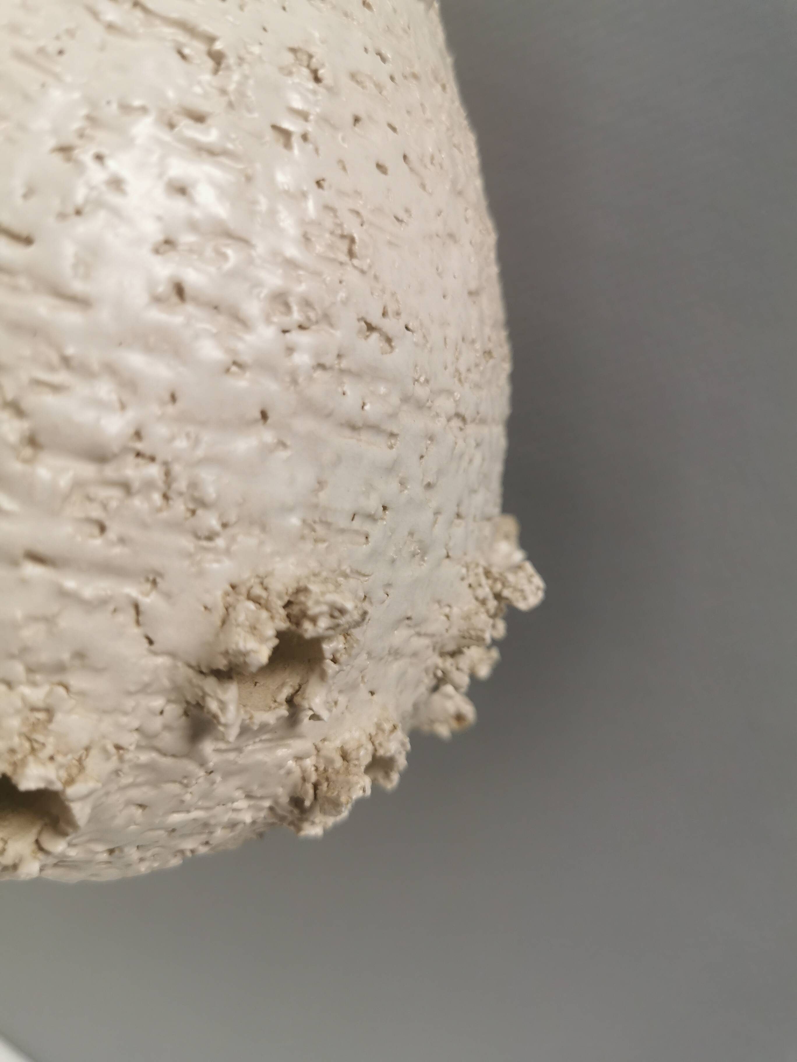 Ceramic hanging lamp in creamy white color that almost looks like a corral
