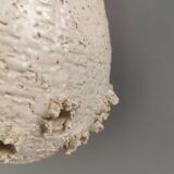 Ceramic hanging lamp in creamy white color that almost looks like a corral