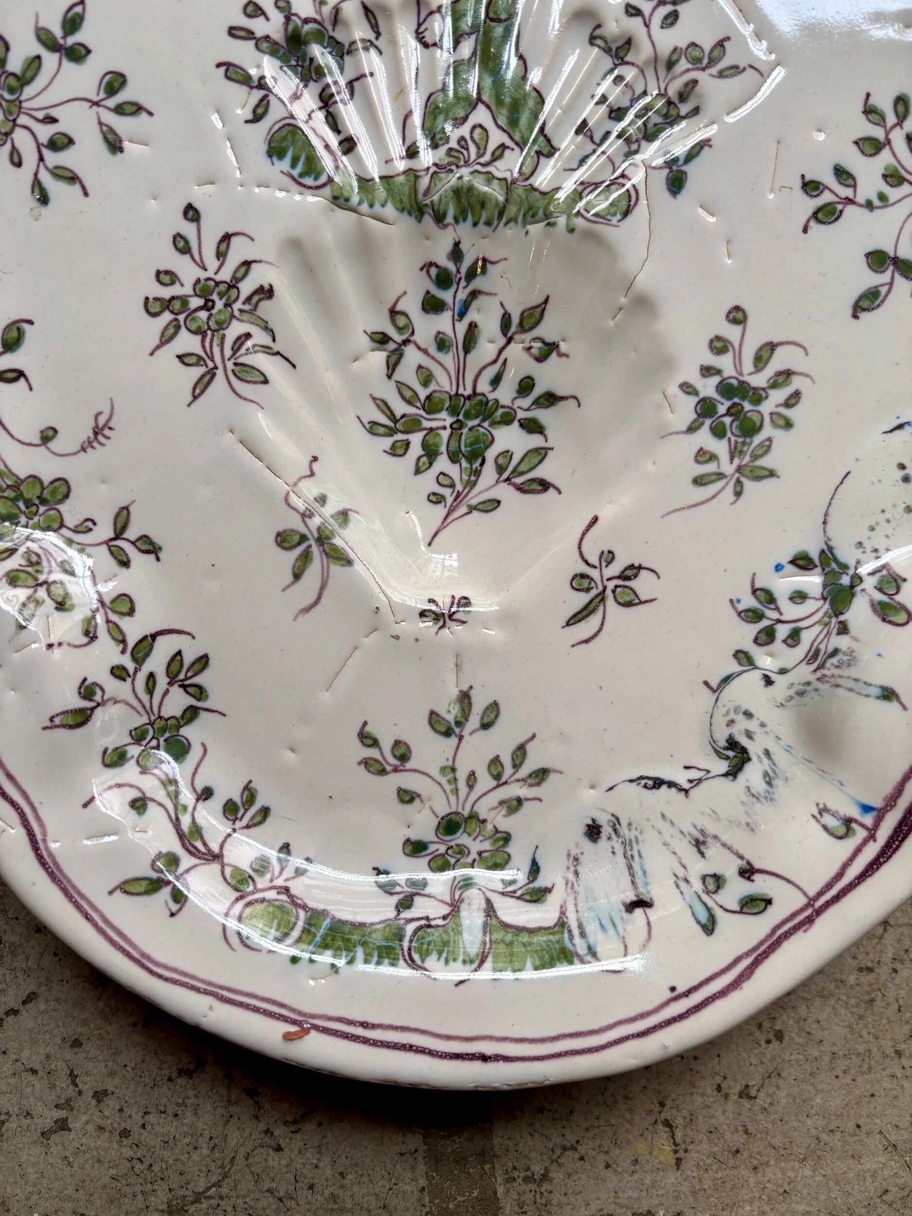 Oval Moustiers plate in cream and green earthenware, 18th century.