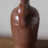 Vintage stoneware liqueur bottle with handle and spout.