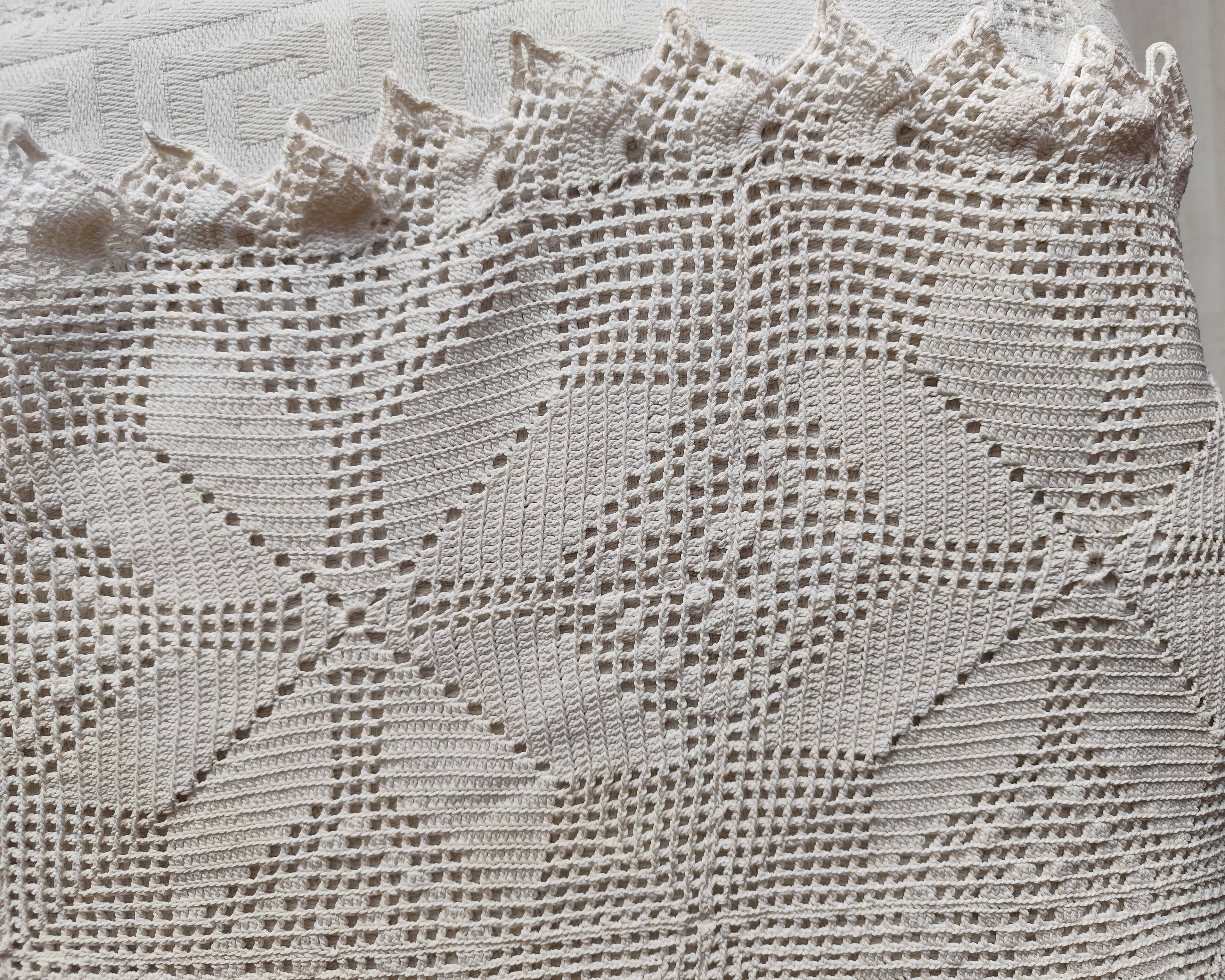 White cotton bedspread, crocheted sofa throw with star patterns