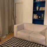 Beige corduroy two-seater sofa