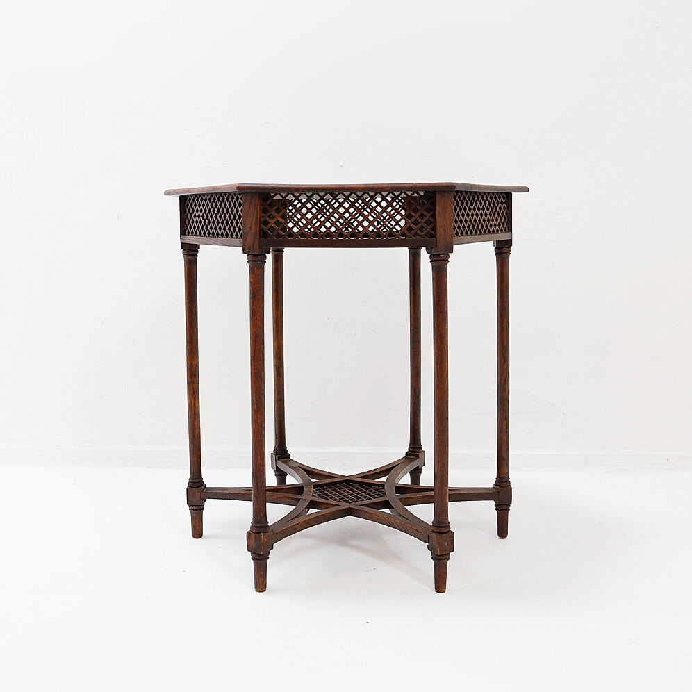 Hexagonal pedestal table or side table with a lattice structure and star pattern.