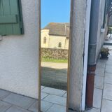 Mirror between two in gilded wood