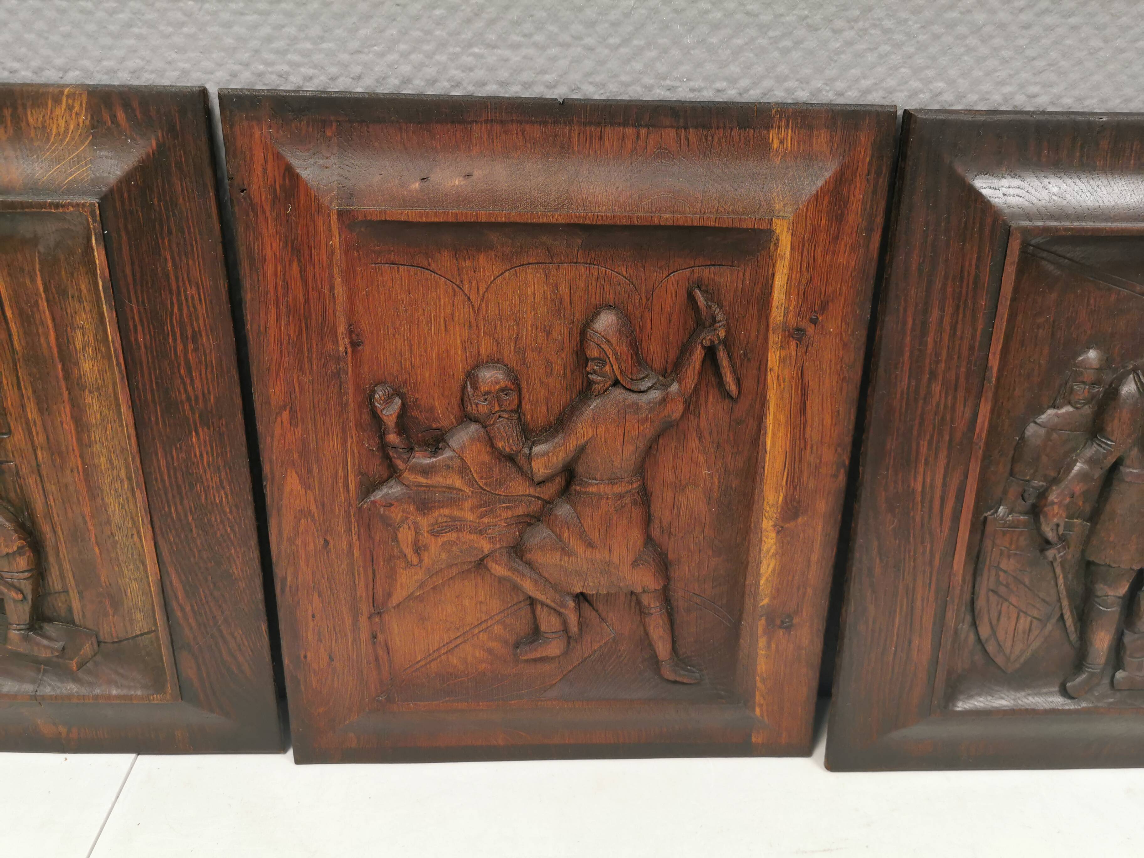Four old wooden carvings to hang on the wall.