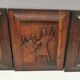 Four old wooden carvings to hang on the wall.