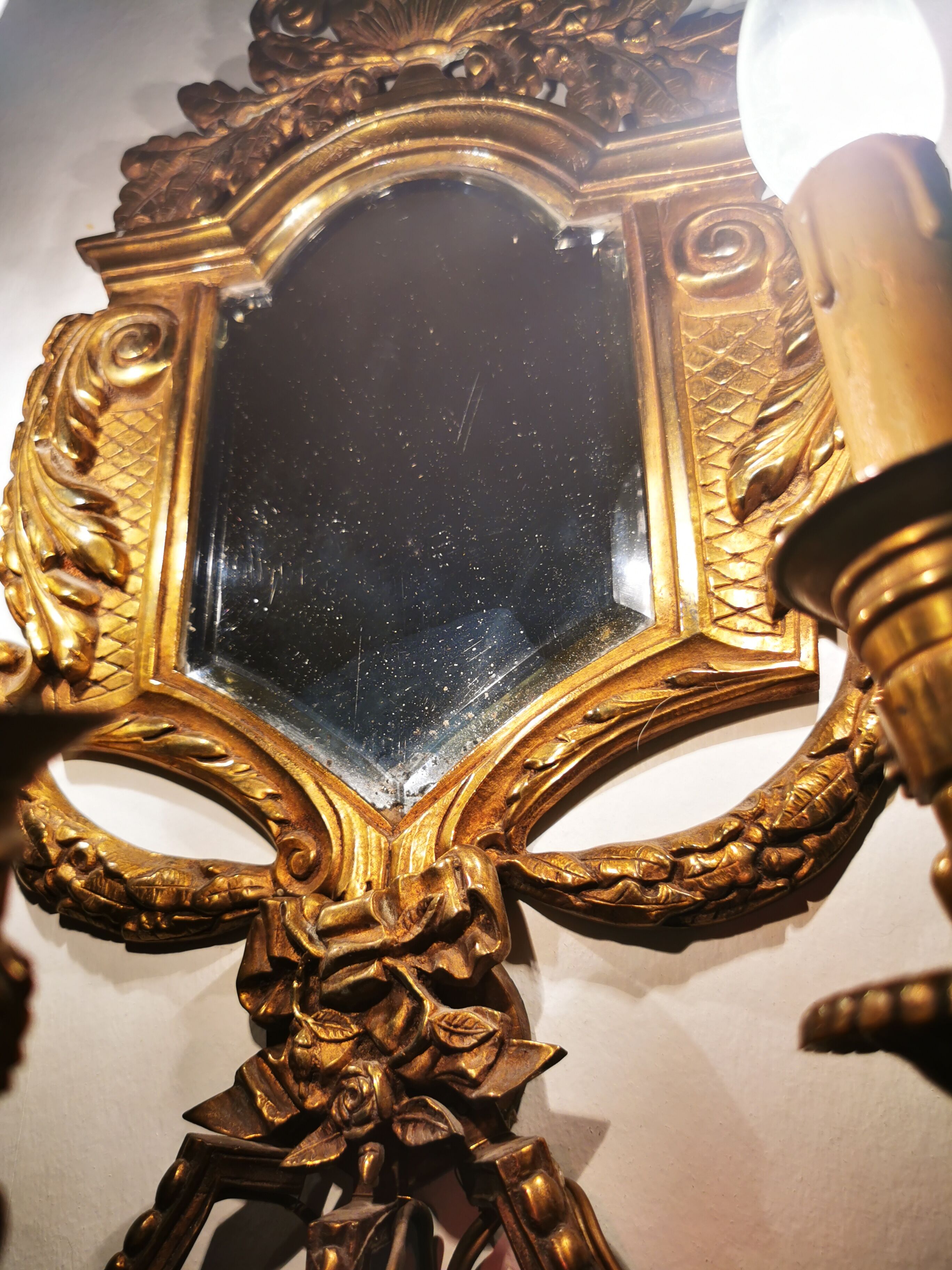 Pair of chissed and gilded bronze mirrors forming appliques