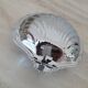Scallop shell butter dish in stainless steel with its white glass saucer.