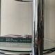 Round tubular bookcase in chrome and glass, 1970 design