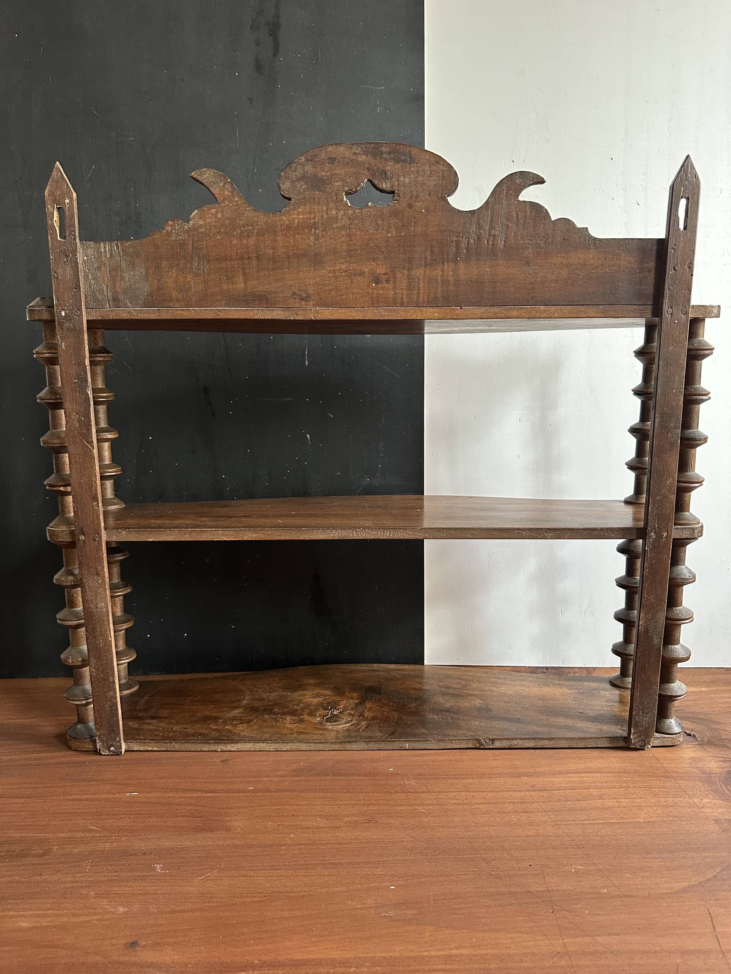 Antique wall shelf made of turned wood and spools of thread, late 19th century.