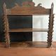Antique wall shelf made of turned wood and spools of thread, late 19th century.