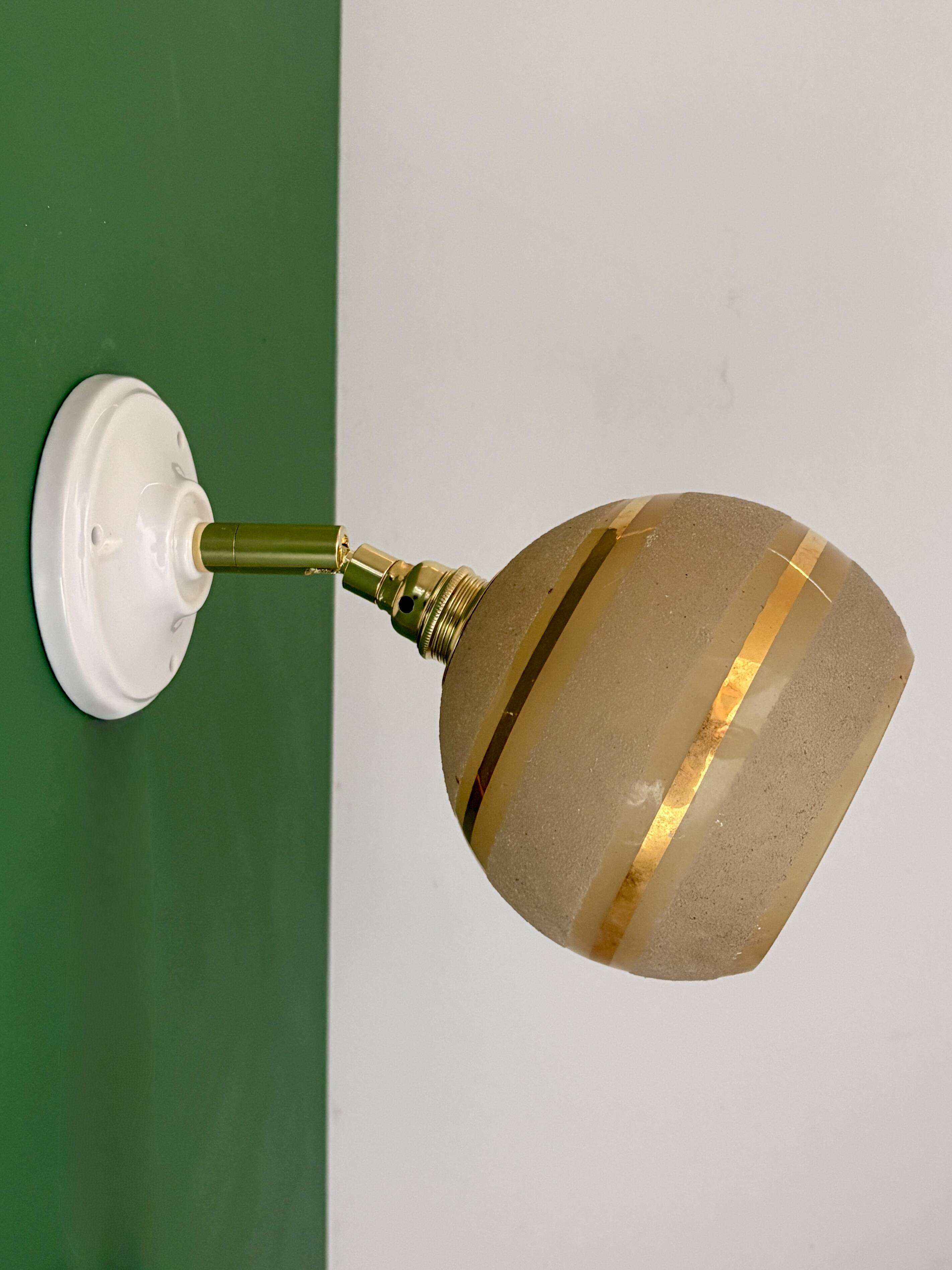 Vintage globe wall light in frosted yellow and gold glass.