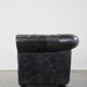 Spacious black cow leather chesterfield armchair with distinctive character