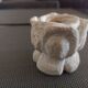 Candlestick in carved stone, signed