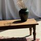 Brown Indonesian teak coffee table, with a border and cylindrical legs H40 L103.