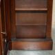 Corner library made of flamed hardwood, in 3 parts.