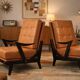 Paire de fauteuils vintage années 50 en bois noir et cuir caramel