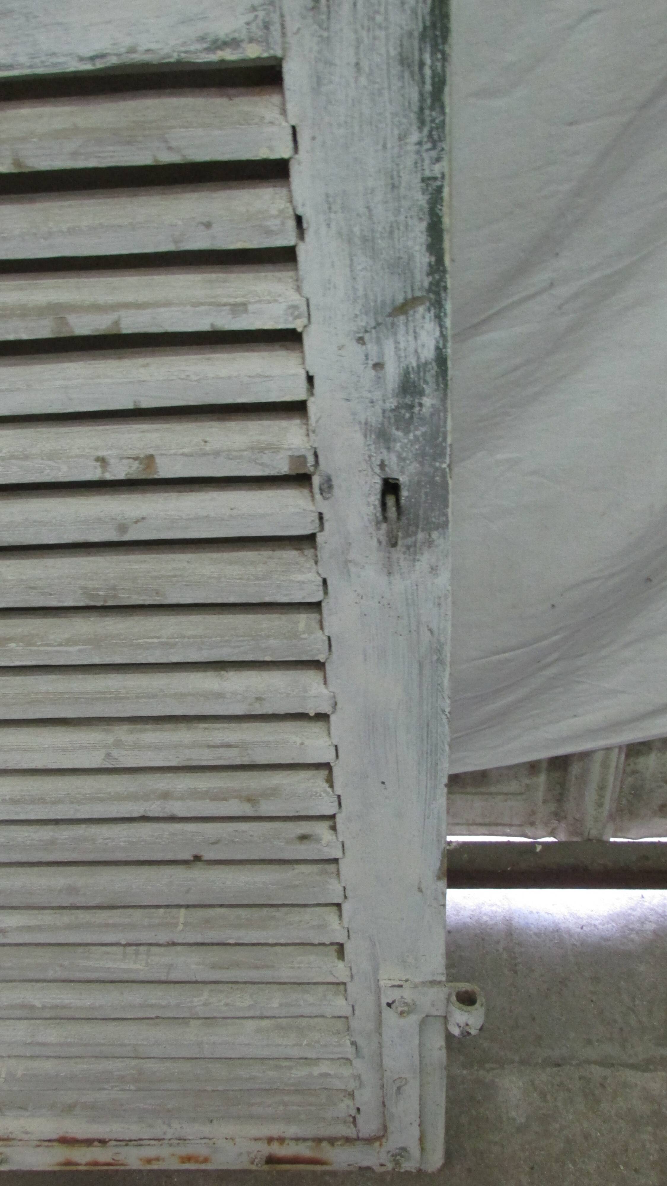 Old wooden shutter with perforations.