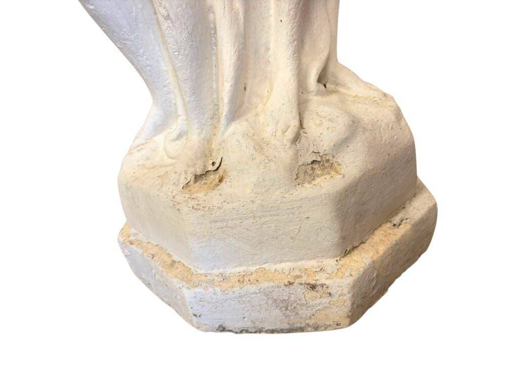 Vintage white concrete garden statue adorned with planter.