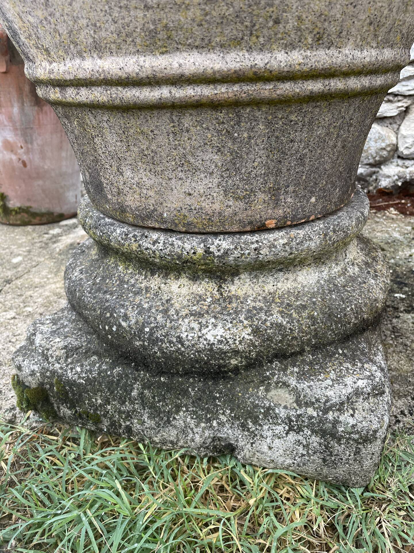 Large Cretan jar in terracotta with three handles on a stone base.