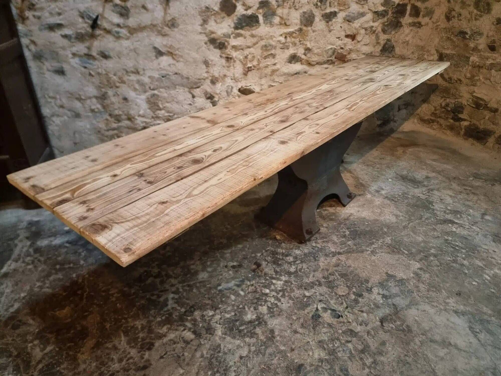 Old French industrial table with a cast iron base and a pine top.