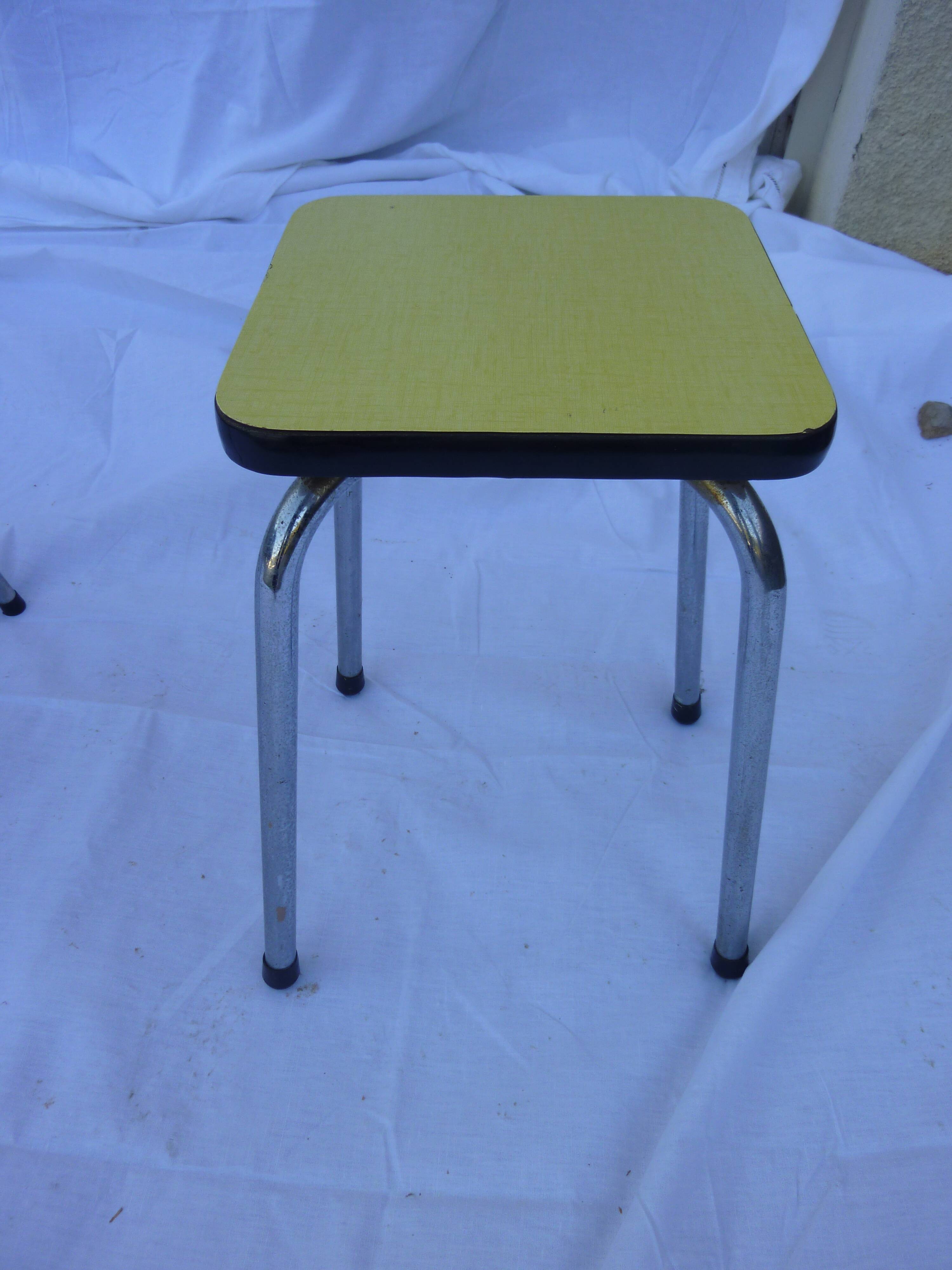 Two chairs and a yellow and blue stool in formica