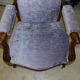 Relaxed Voltaire armchair with walnut racks