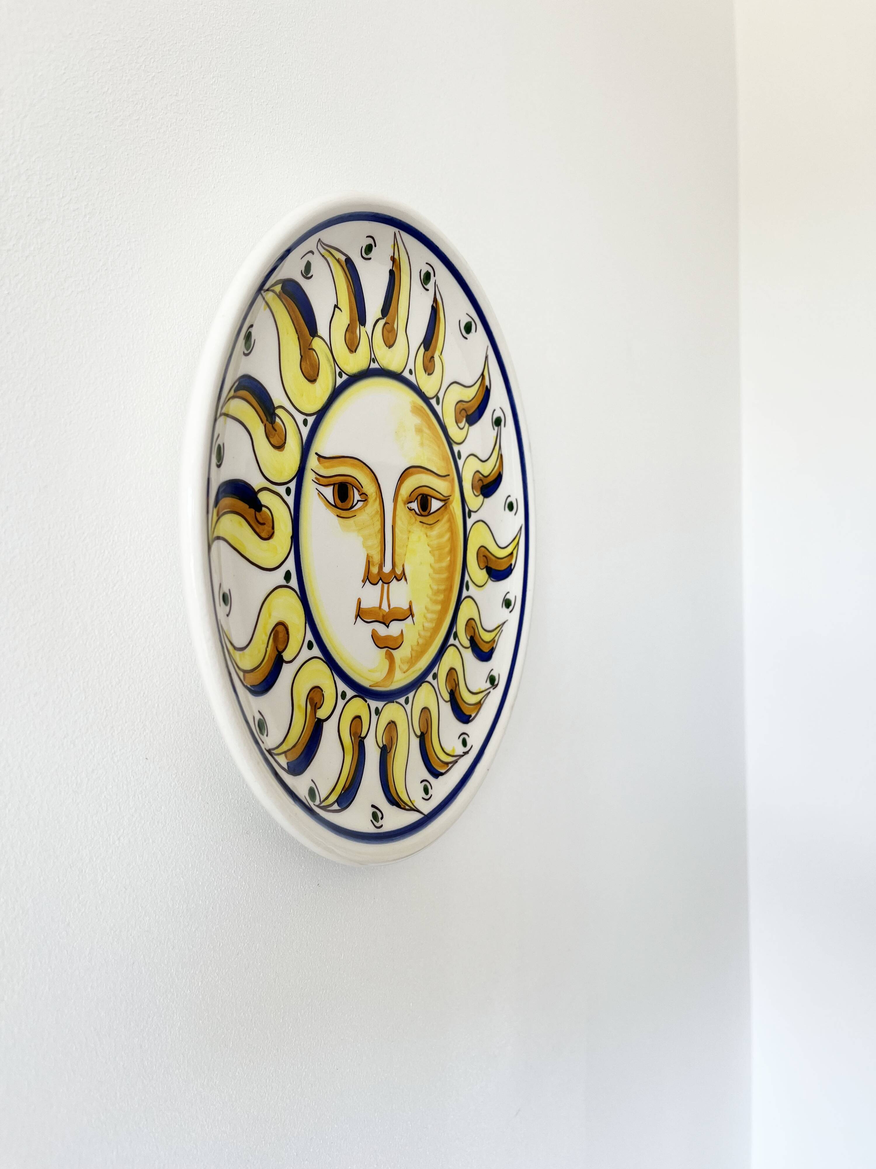 Decorative ceramic plate with sun face