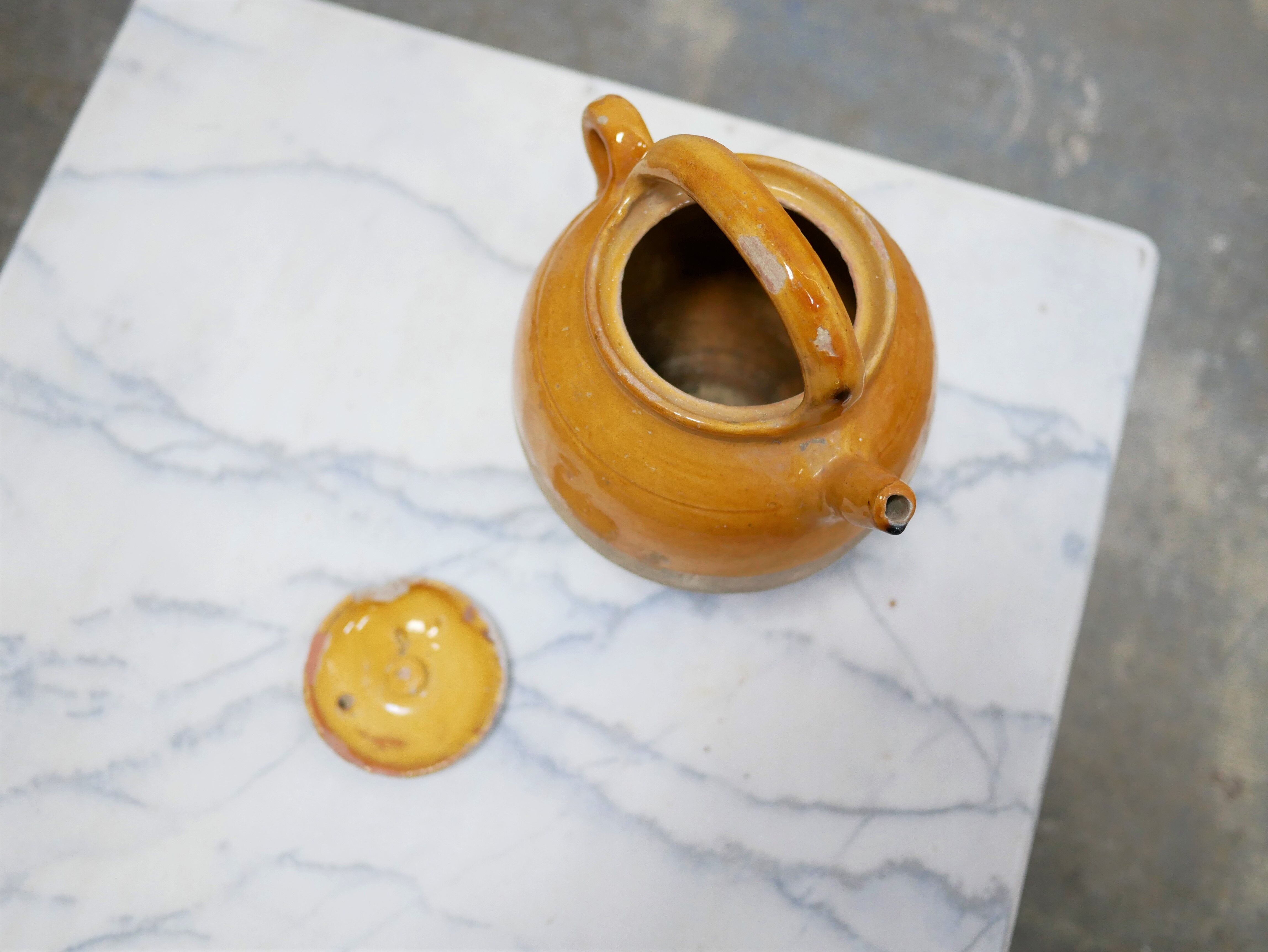 Old gargoulette pot in glazed terracotta