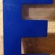 Letter E vintage sign in blue plexiglass