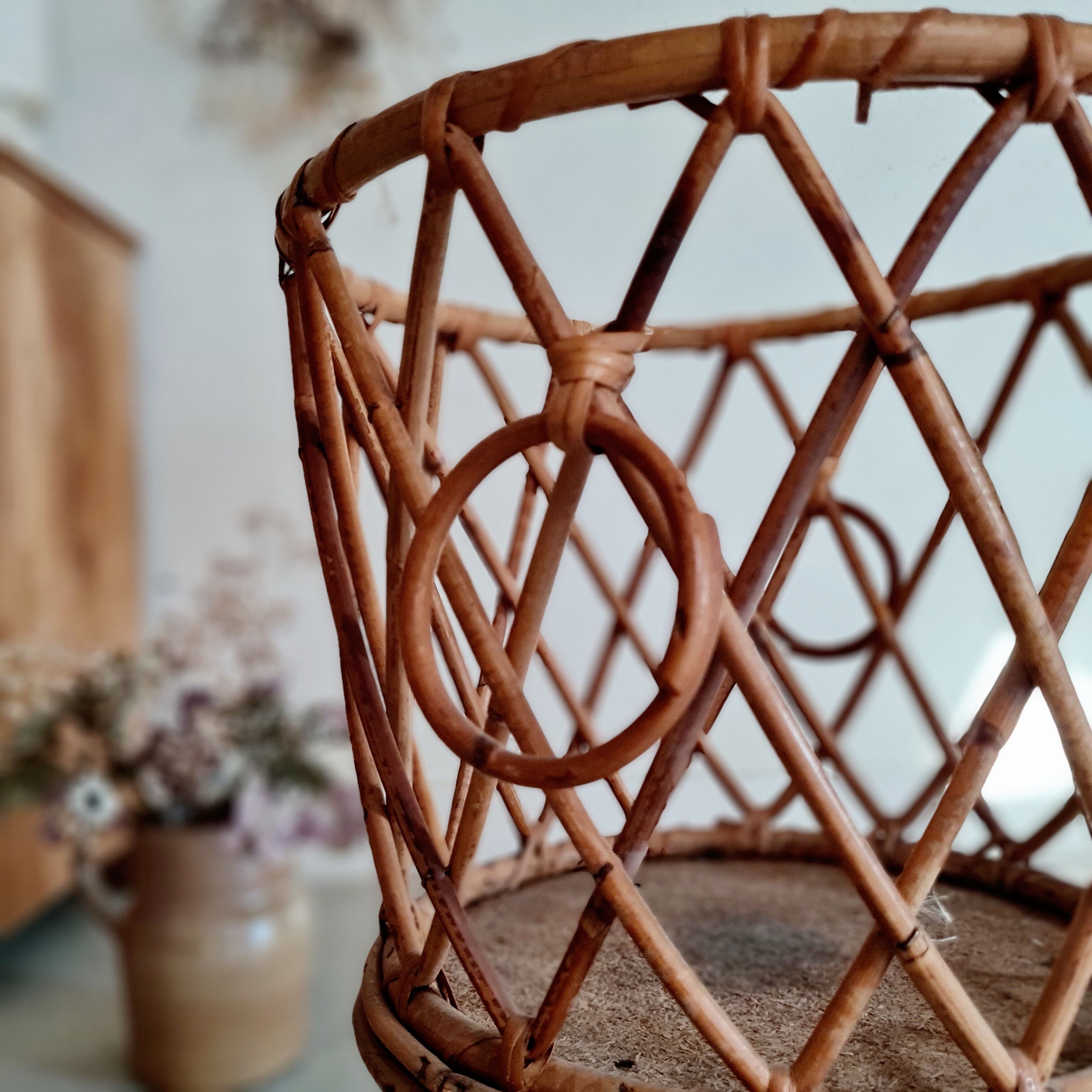 Old tripod rattan plant holder