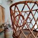 Old tripod rattan plant holder