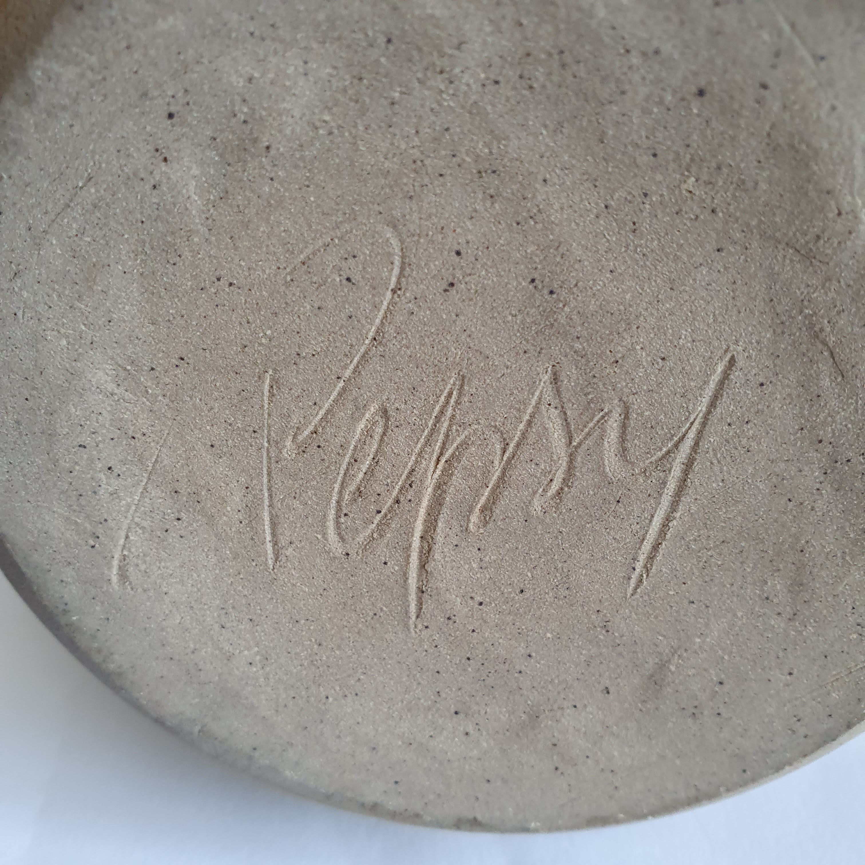 Enamelled sandstone pitcher signed