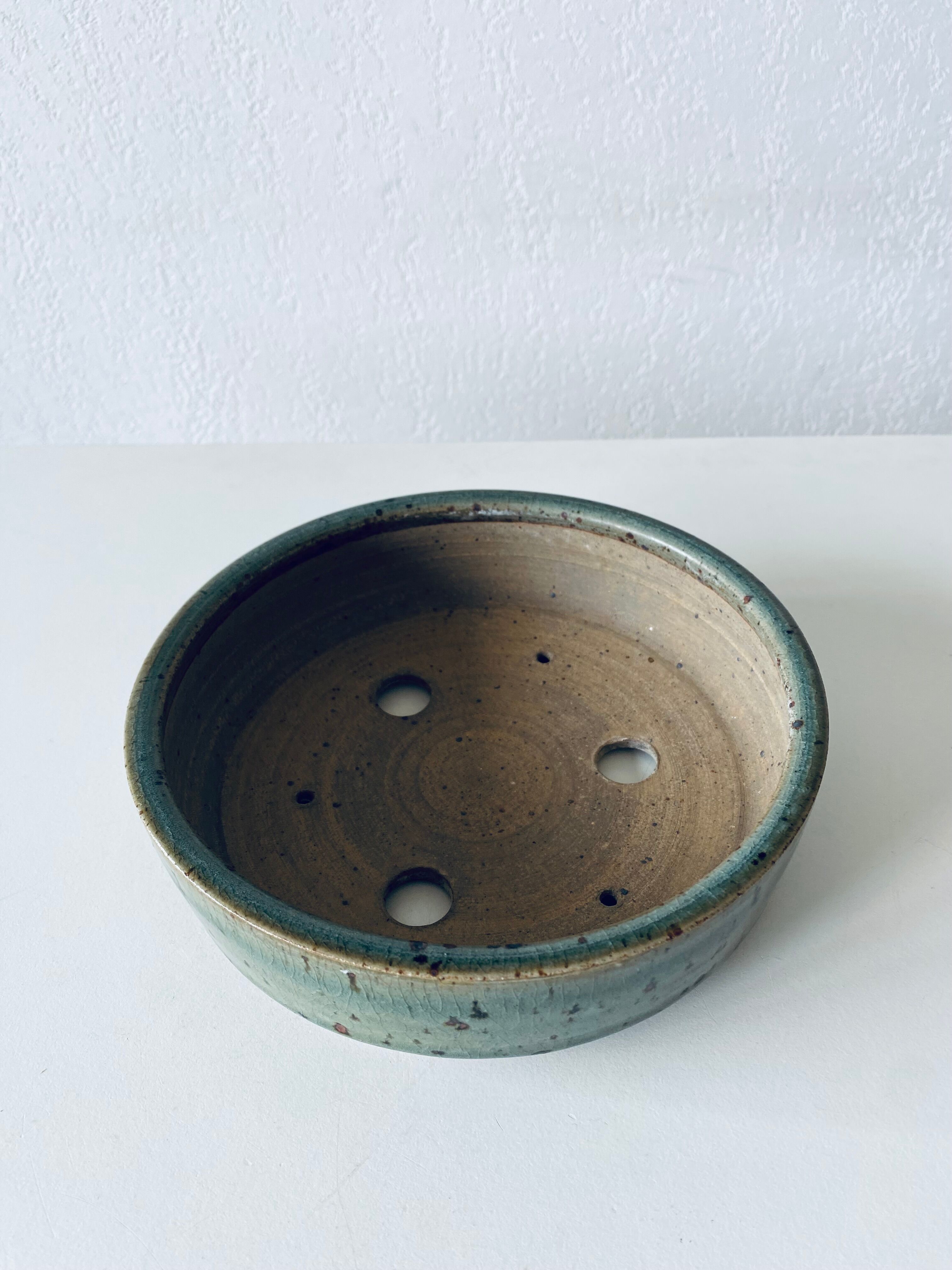 Pierced glazed stoneware cup