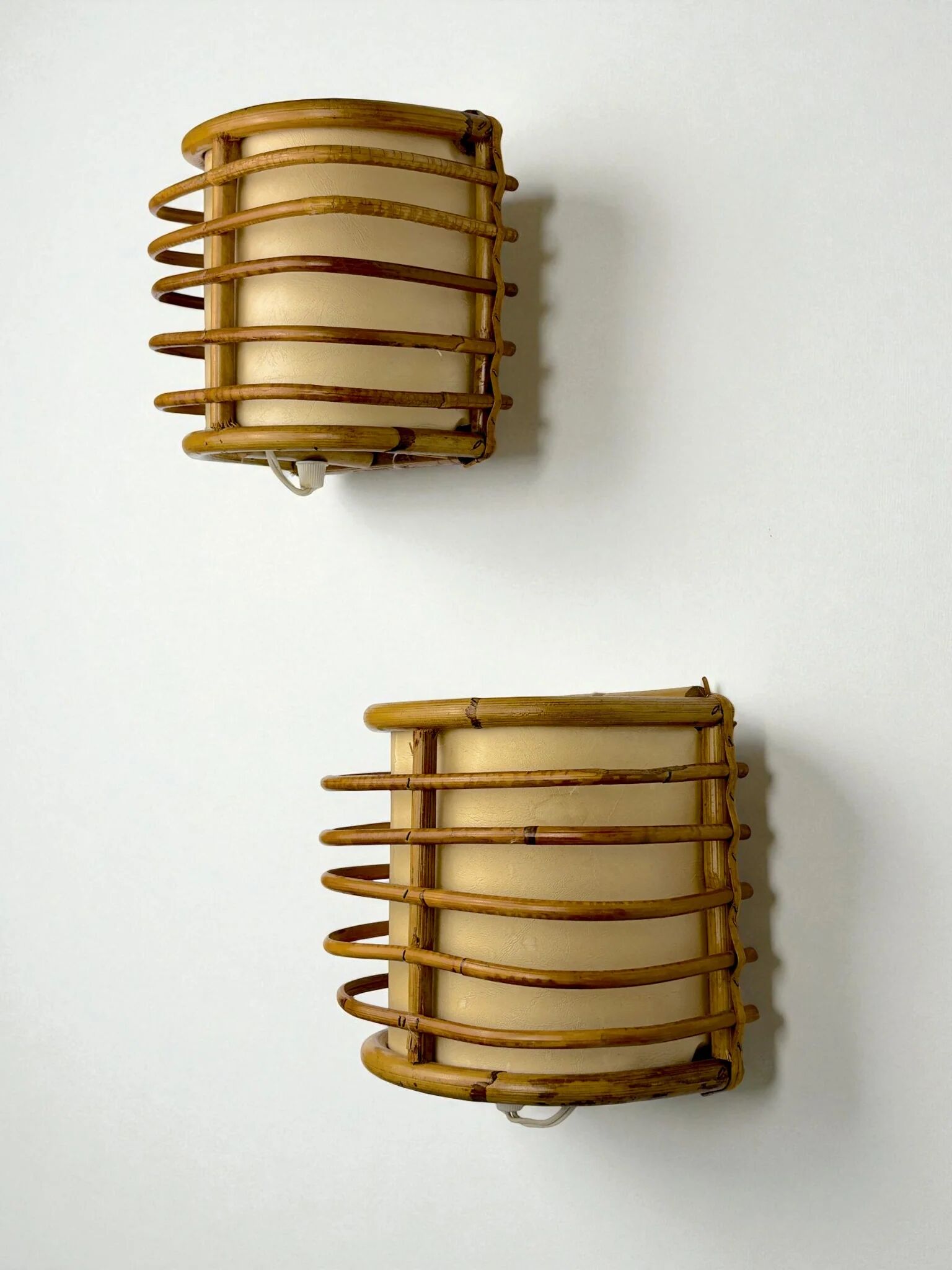 Pair of mid-century rattan wall sconces, circa 1960s, Italy